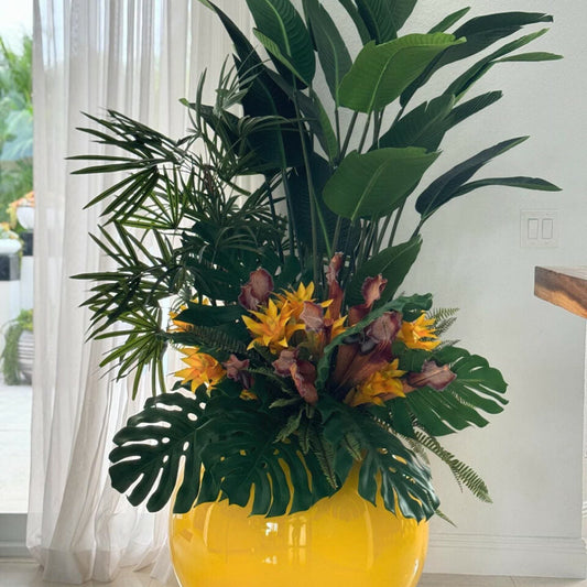 Mix of Tropical Plants in a Yellow Globe Planter